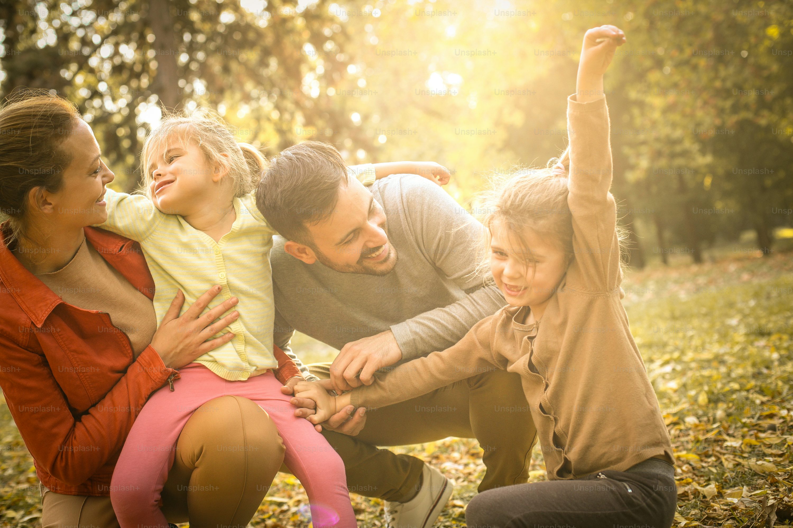 Grandparents hugging their grandkids at a park